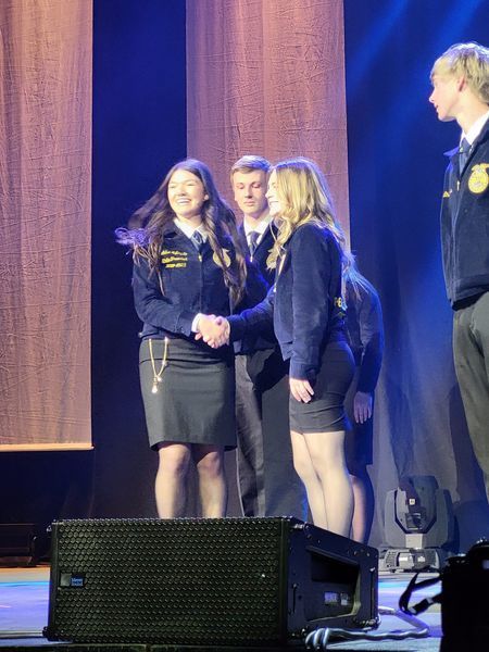 ffa students on stage shaking hands