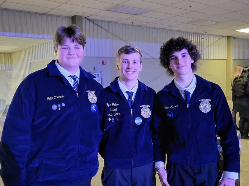 three ffa students in uniform posing for picture 